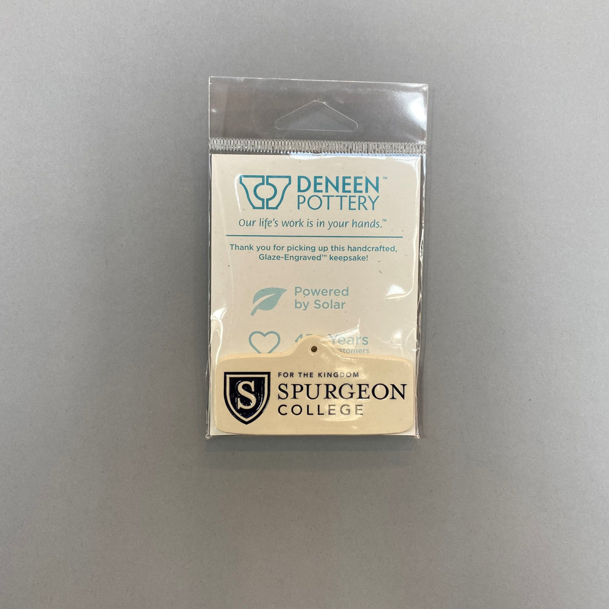 These Glaze Engrave ornaments from Deneen Pottery come with a gold hook.
The color option refers to the fill, seen especially in the seals.